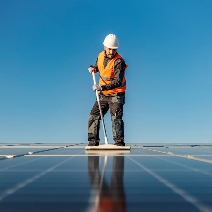 a cleaner showing how to clean a solar panel